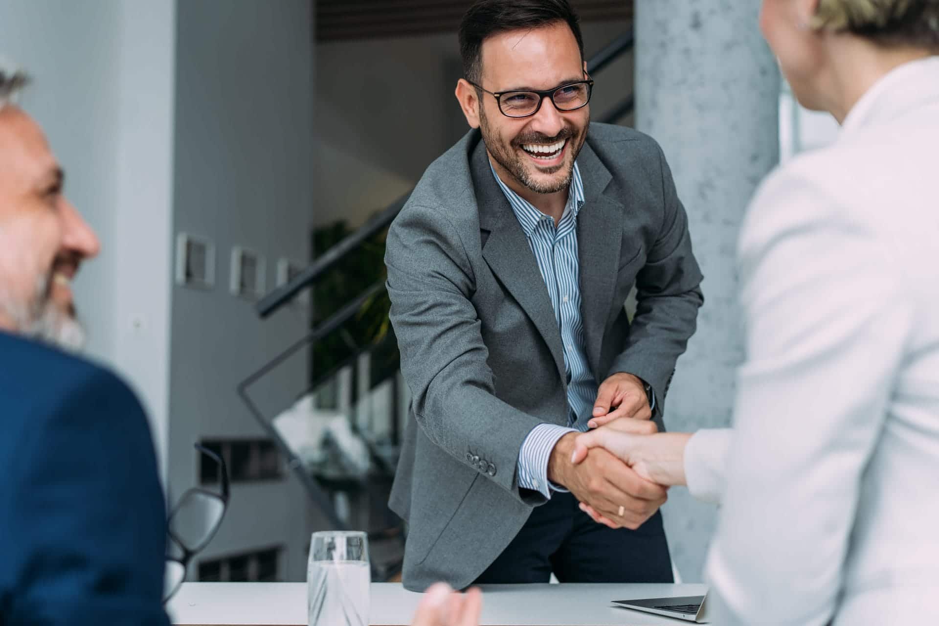 Business professionals shaking hands during a meeting