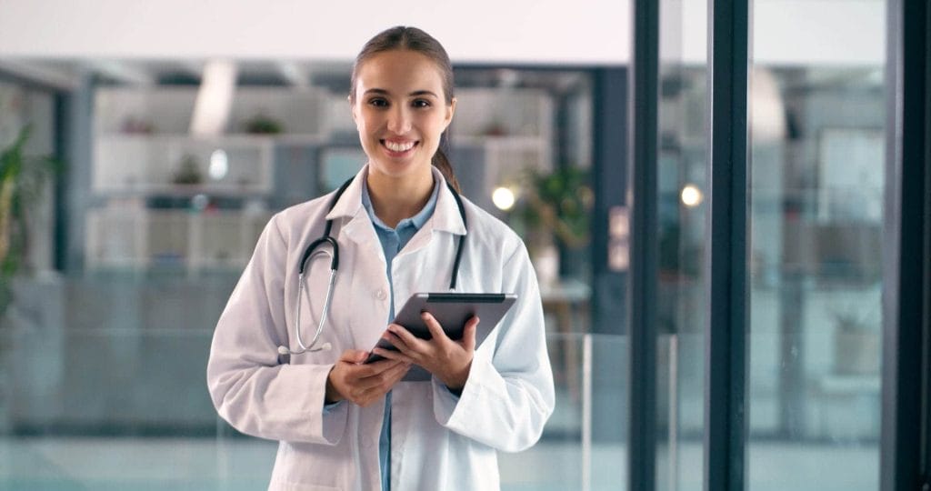Healthcare professional holding a tablet in a modern medical facility