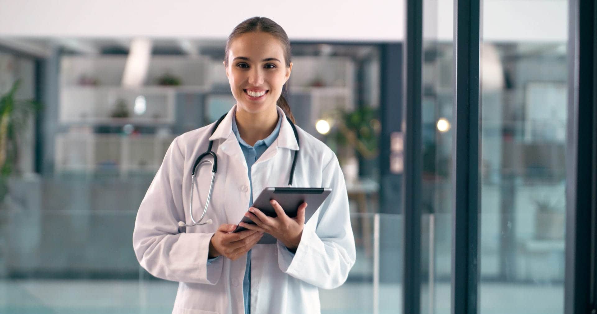 Healthcare professional holding a tablet in a modern medical facility
