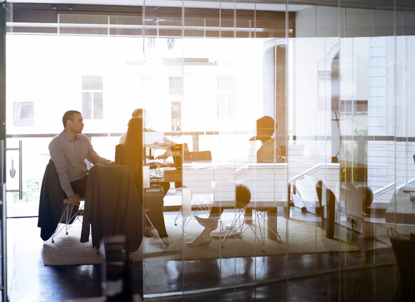 Professionals meeting in a glass-walled modern office
